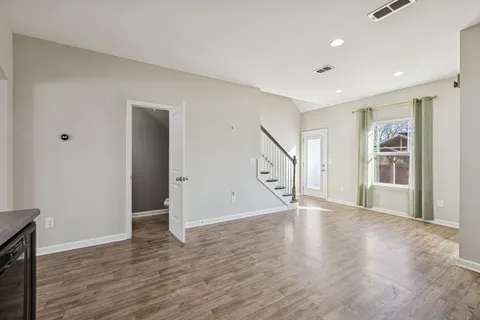 a view of an entryway with wooden floor and door