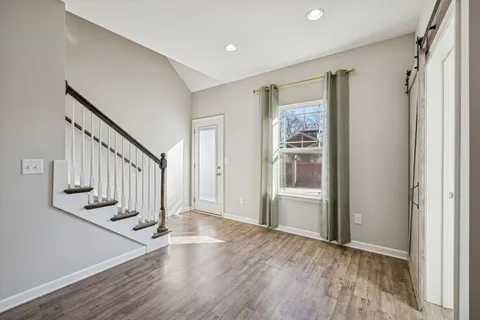 a large kitchen with a large window and stainless steel appliances
