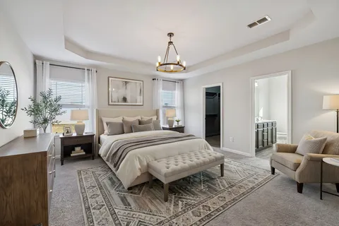 an empty room with chandelier fan and windows
