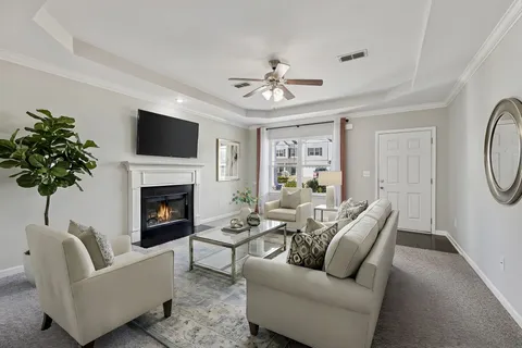 an empty room with windows and fireplace