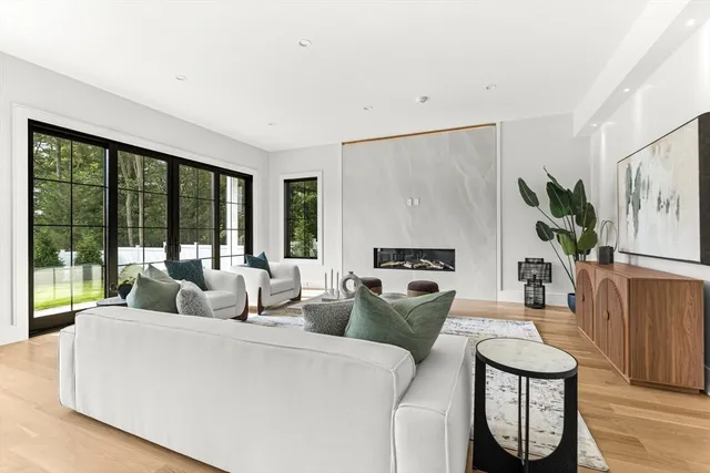 a kitchen with stainless steel appliances granite countertop a dining table chairs refrigerator and sink