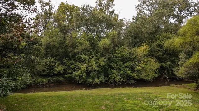 a kitchen with granite countertop a sink stainless steel appliances and cabinets