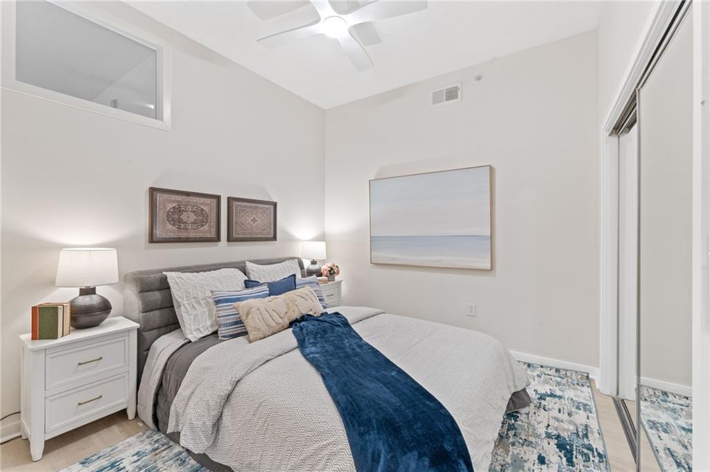 3300 Windy Ridge Parkway Southeast, Unit 809 Atlanta, GA 30339 - Photo 13 of 30 a bed room with a bed and a painting on the wall