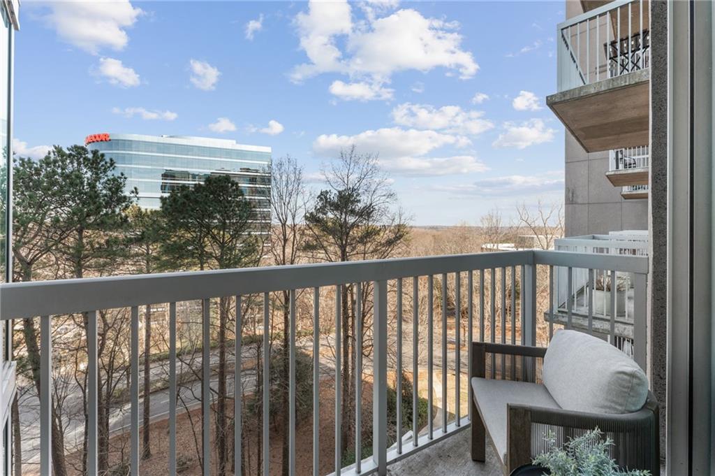 3300 Windy Ridge Parkway Southeast, Unit 809 Atlanta, GA 30339 - Photo 15 of 30 a view of a balcony with wooden chairs