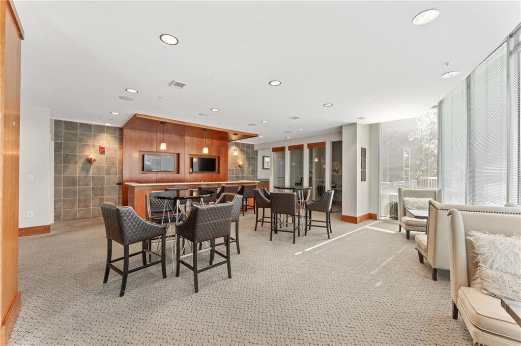 3300 Windy Ridge Parkway Southeast, Unit 809 Atlanta, GA 30339 - Photo 18 of 30 a dining room with furniture and a floor to ceiling window