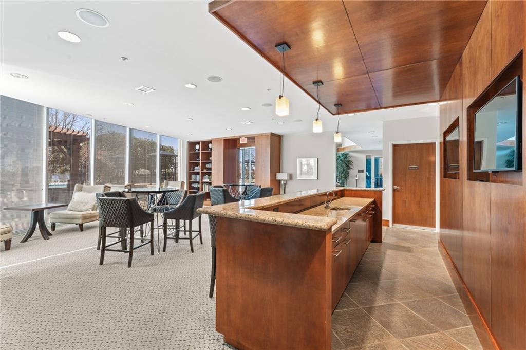 3300 Windy Ridge Parkway Southeast, Unit 809 Atlanta, GA 30339 - Photo 19 of 30 a very nice looking living room with a large dining table and a large window with wooden floor