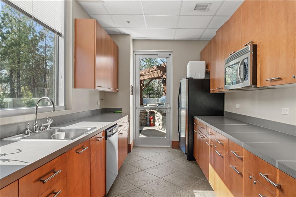 3300 Windy Ridge Parkway Southeast, Unit 809 Atlanta, GA 30339 - Photo 20 of 30 a kitchen with stainless steel appliances granite countertop a sink and a stove