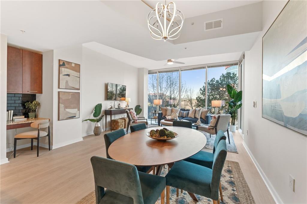 3300 Windy Ridge Parkway Southeast, Unit 809 Atlanta, GA 30339 - Photo 7 of 30 a view of a dining room with furniture window and wooden floor