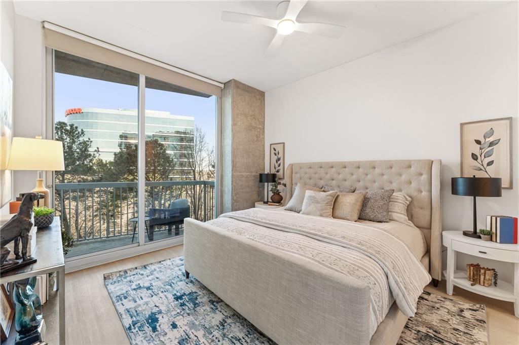 3300 Windy Ridge Parkway Southeast, Unit 809 Atlanta, GA 30339 - Photo 9 of 30 a bedroom with a large bed and a balcony view