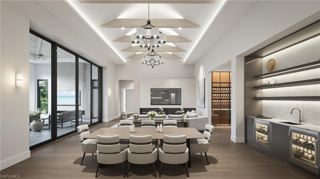 444 Orchid Drive Naples, FL 34102 - Photo 15 of 24 a large white kitchen with a large window and stainless steel appliances