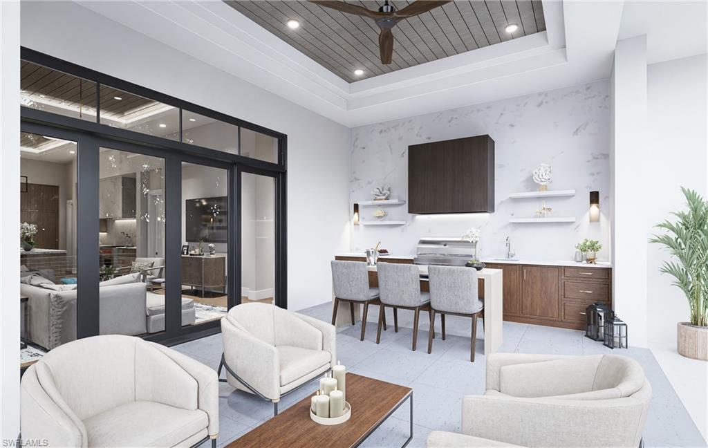 444 Orchid Drive Naples, FL 34102 - Photo 16 of 24 a living room with furniture a flat screen tv and kitchen view