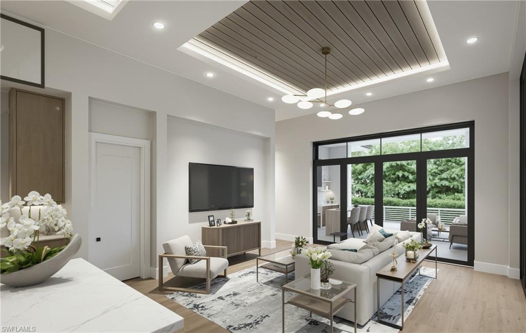 444 Orchid Drive Naples, FL 34102 - Photo 6 of 24 a living room with furniture tv and large window