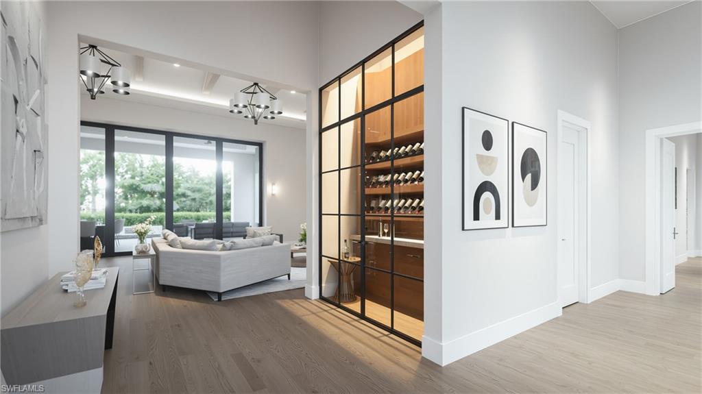 444 Orchid Drive Naples, FL 34102 - Photo 8 of 24 a living room with furniture and large windows