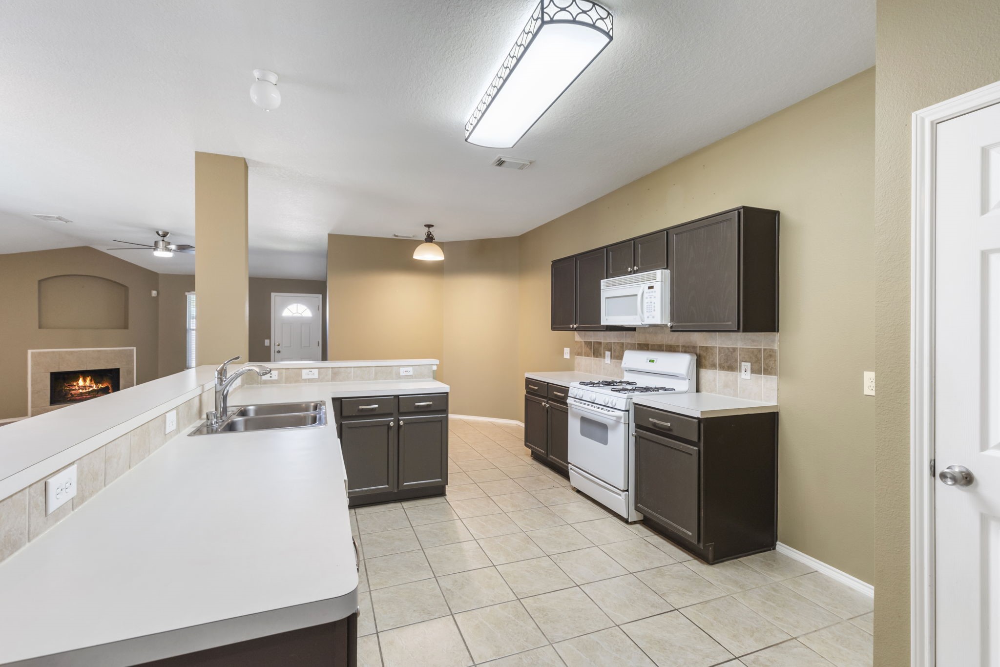 4815 Rustic Field Lane Katy, TX 77449 - Photo 11 of 47 a kitchen with stainless steel appliances granite countertop a sink stove and refrigerator