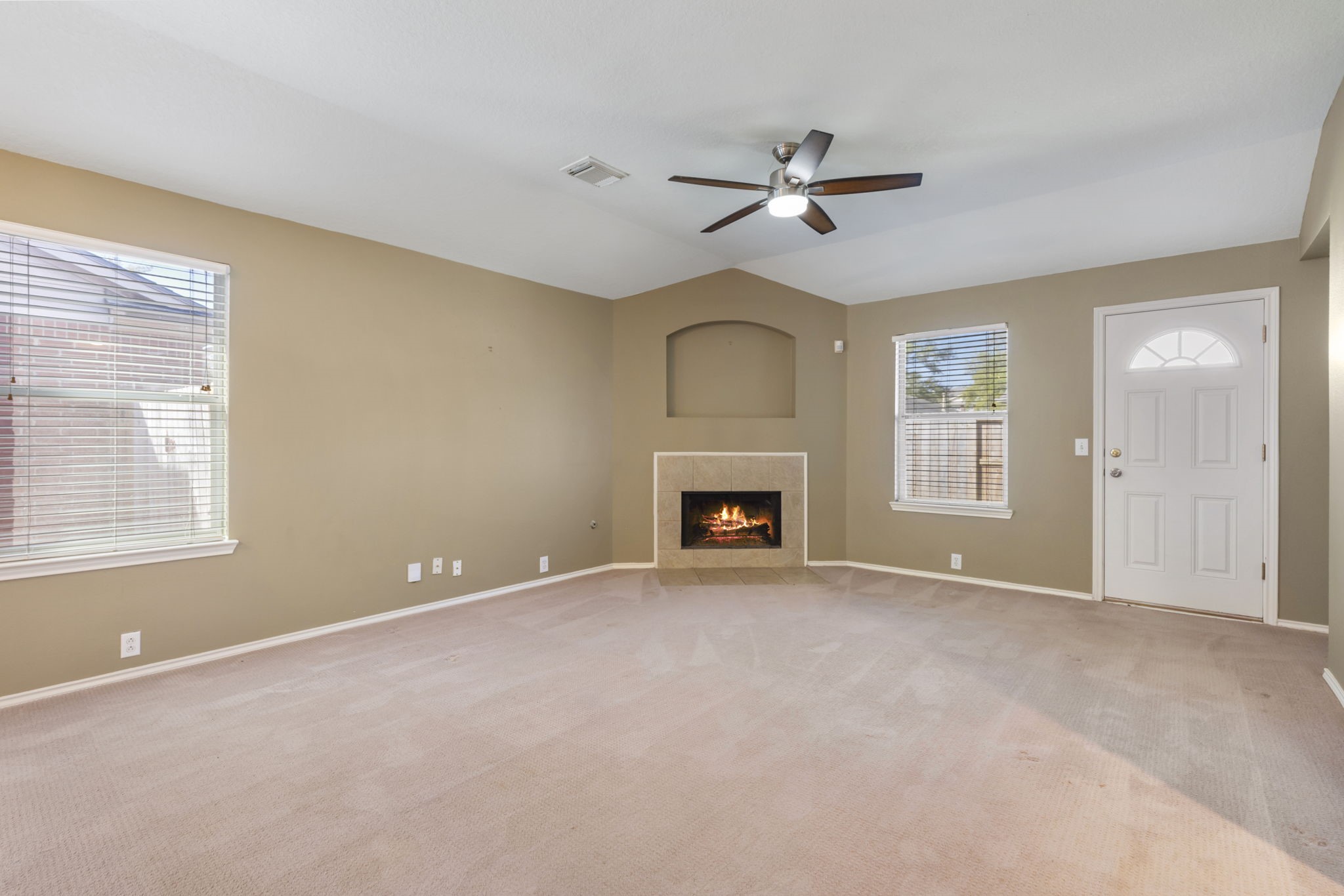 4815 Rustic Field Lane Katy, TX 77449 - Photo 14 of 47 an empty room with windows and fireplace