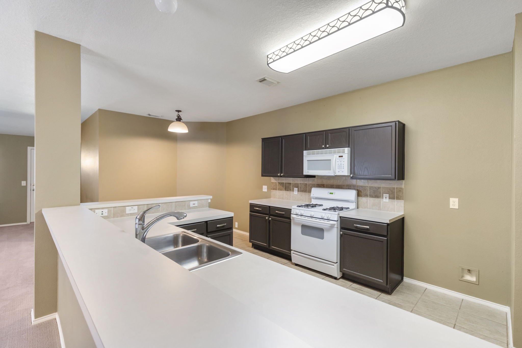4815 Rustic Field Lane Katy, TX 77449 - Photo 20 of 47 a view of a kitchen with a sink and cabinets