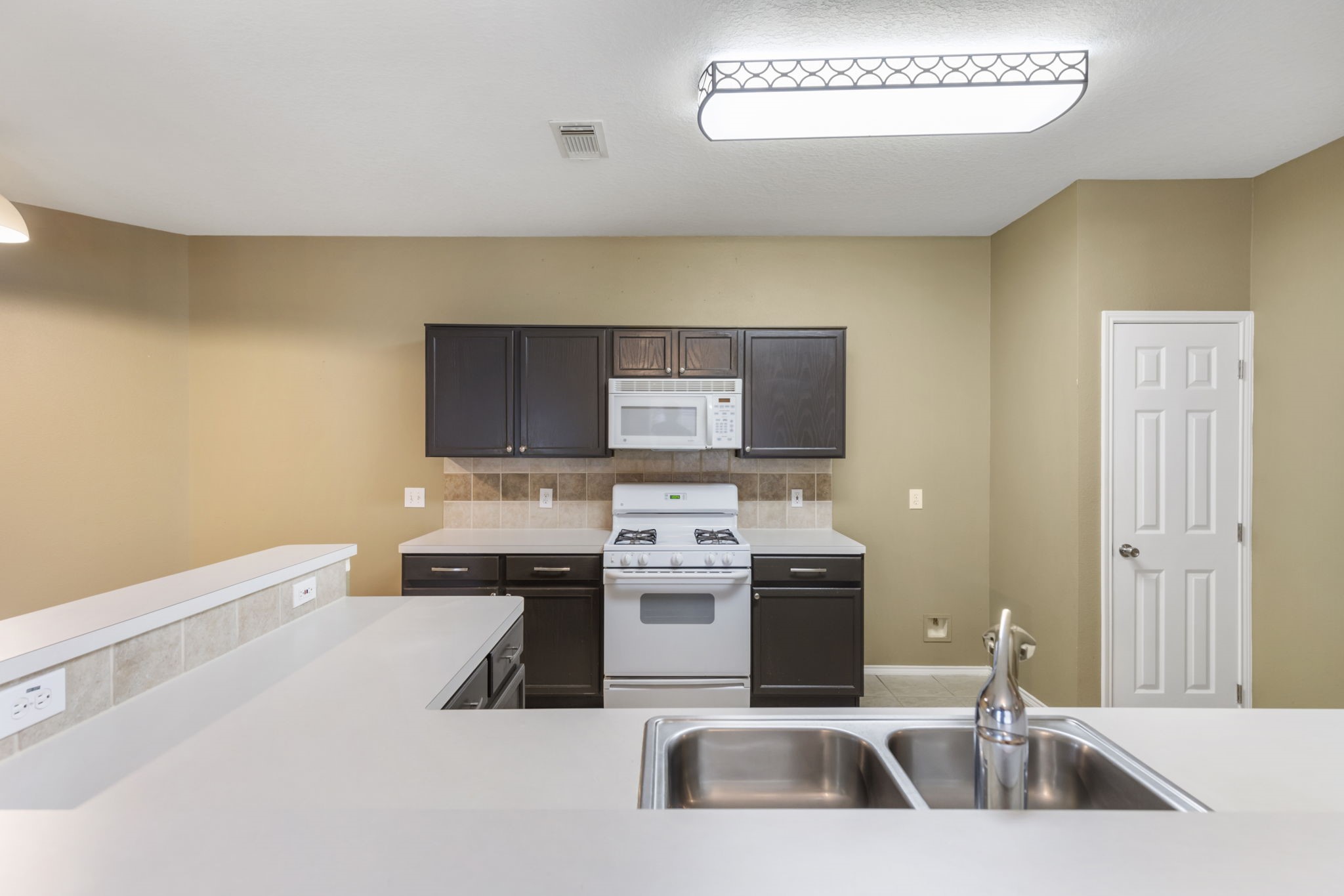 4815 Rustic Field Lane Katy, TX 77449 - Photo 21 of 47 a kitchen with a sink stove and cabinets