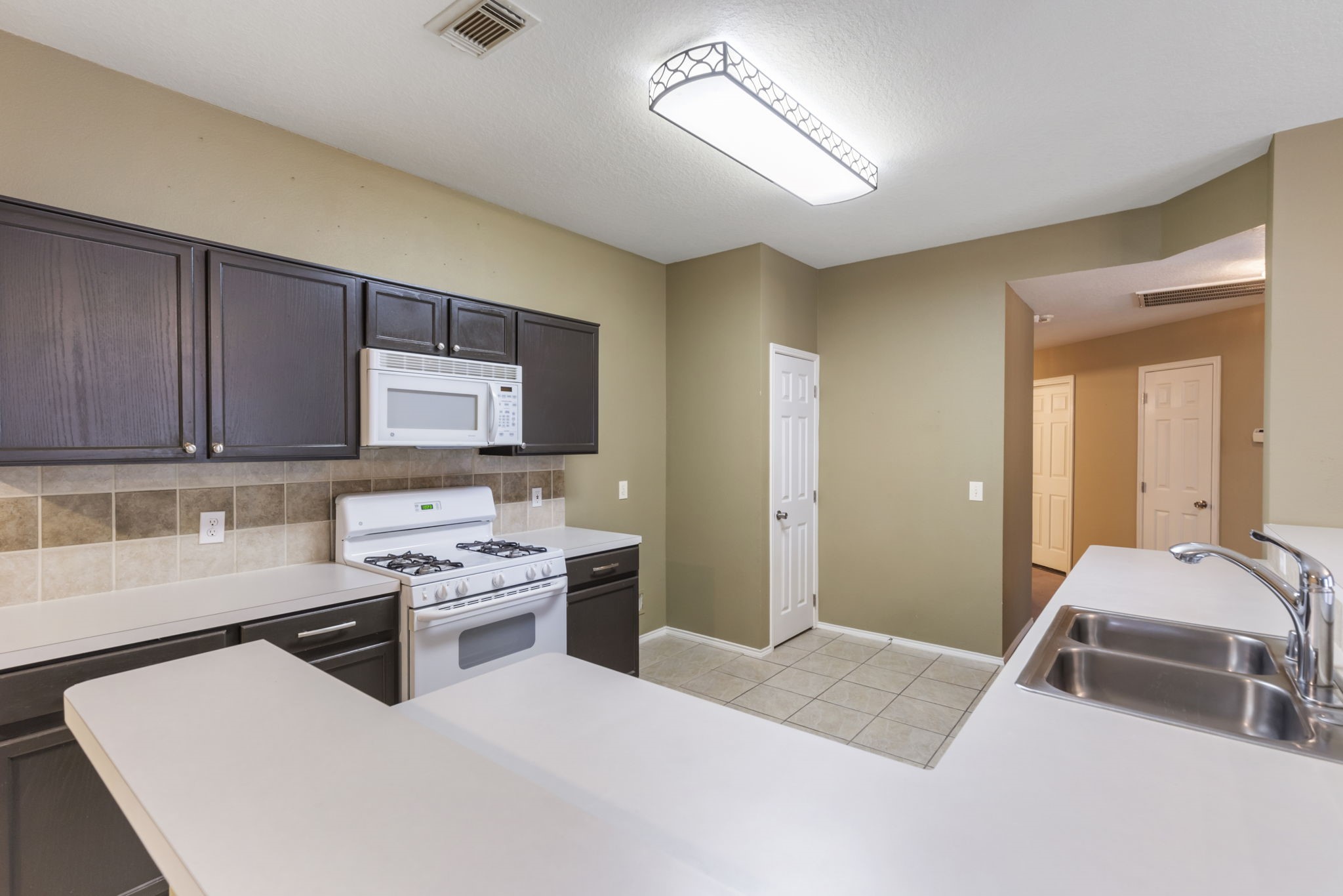 4815 Rustic Field Lane Katy, TX 77449 - Photo 22 of 47 a kitchen with a stove and a refrigerator