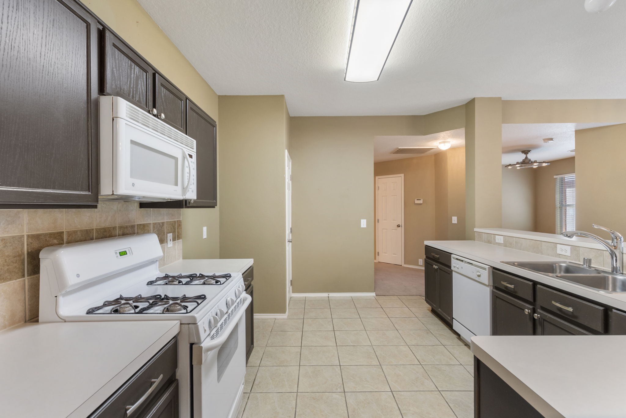 4815 Rustic Field Lane Katy, TX 77449 - Photo 23 of 47 a kitchen with a stove and a sink