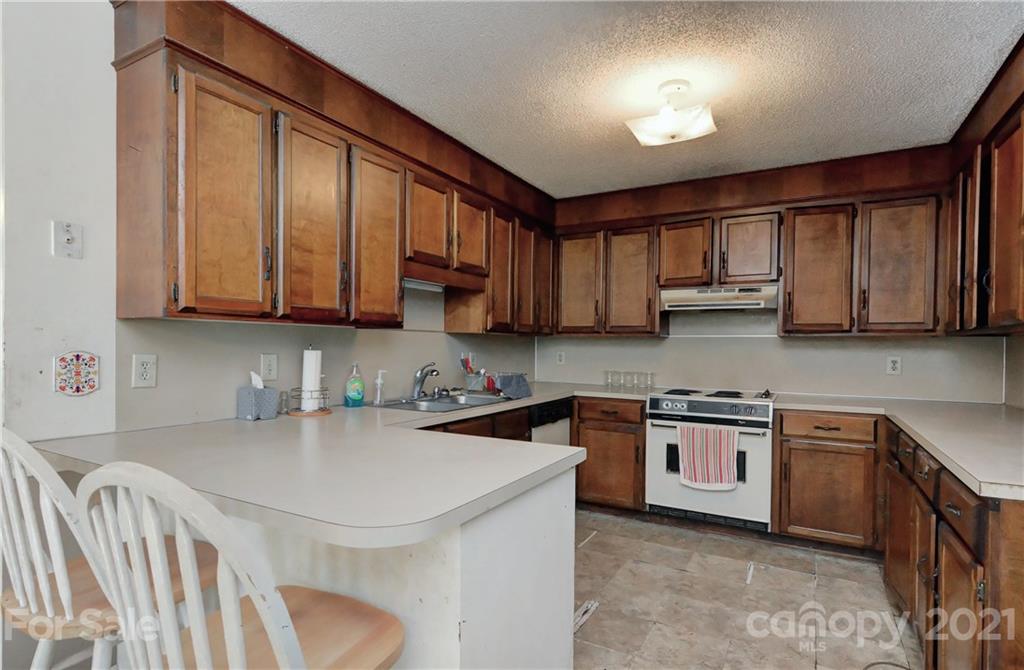 3621 Austin Road Monroe, NC 28112 - Photo 14 of 28 a kitchen with stainless steel appliances granite countertop a sink stove and cabinets