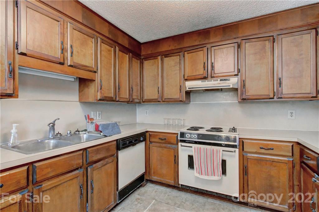3621 Austin Road Monroe, NC 28112 - Photo 15 of 28 a kitchen with stainless steel appliances granite countertop a sink dishwasher stove and cabinets with wooden floor