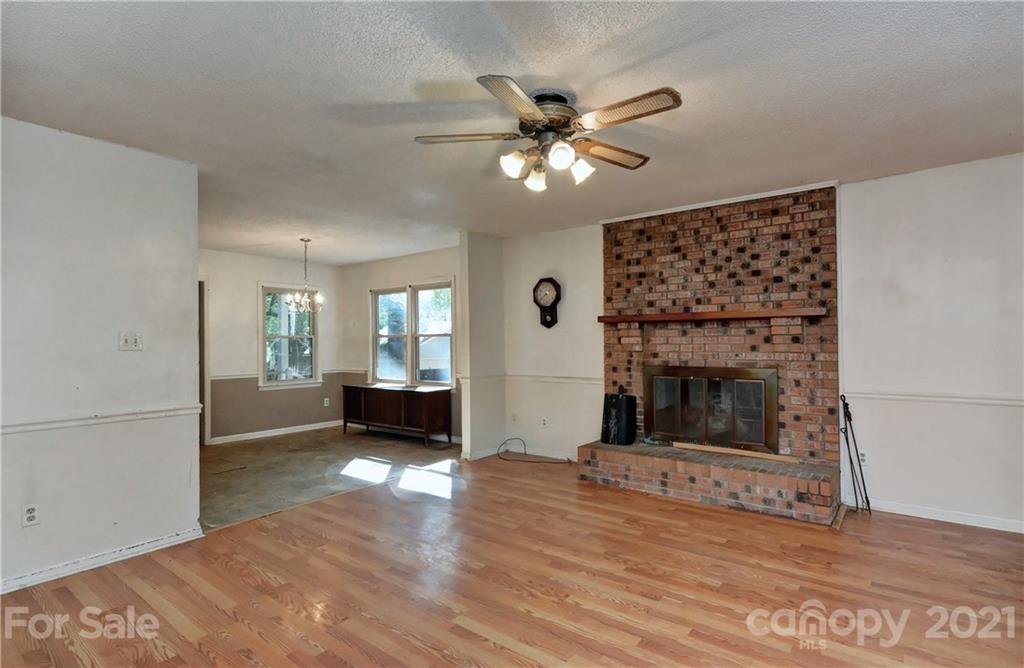 3621 Austin Road Monroe, NC 28112 - Photo 16 of 28 a view of a livingroom with wooden floor a ceiling fan and a window