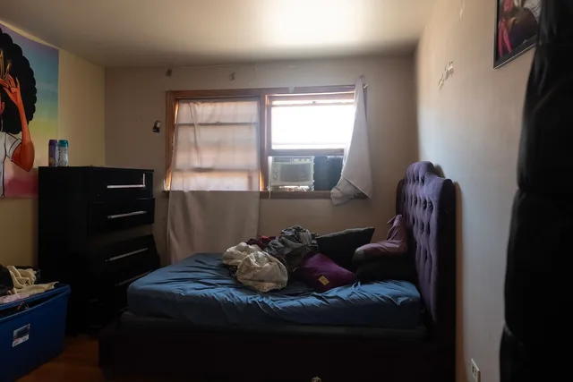 a bed room with a bed and a window