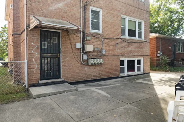 a view of a house with a door and a yard
