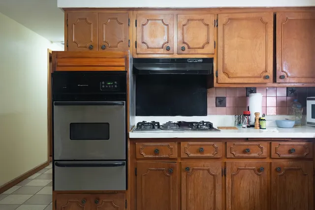 a kitchen with stainless steel appliances granite countertop a stove and a microwave