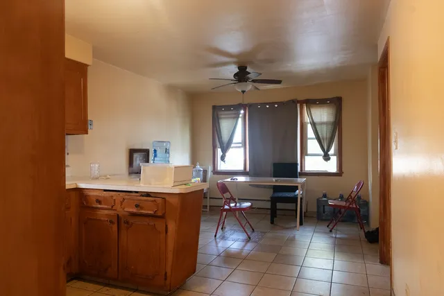 a view of a hallway with workspace and a window