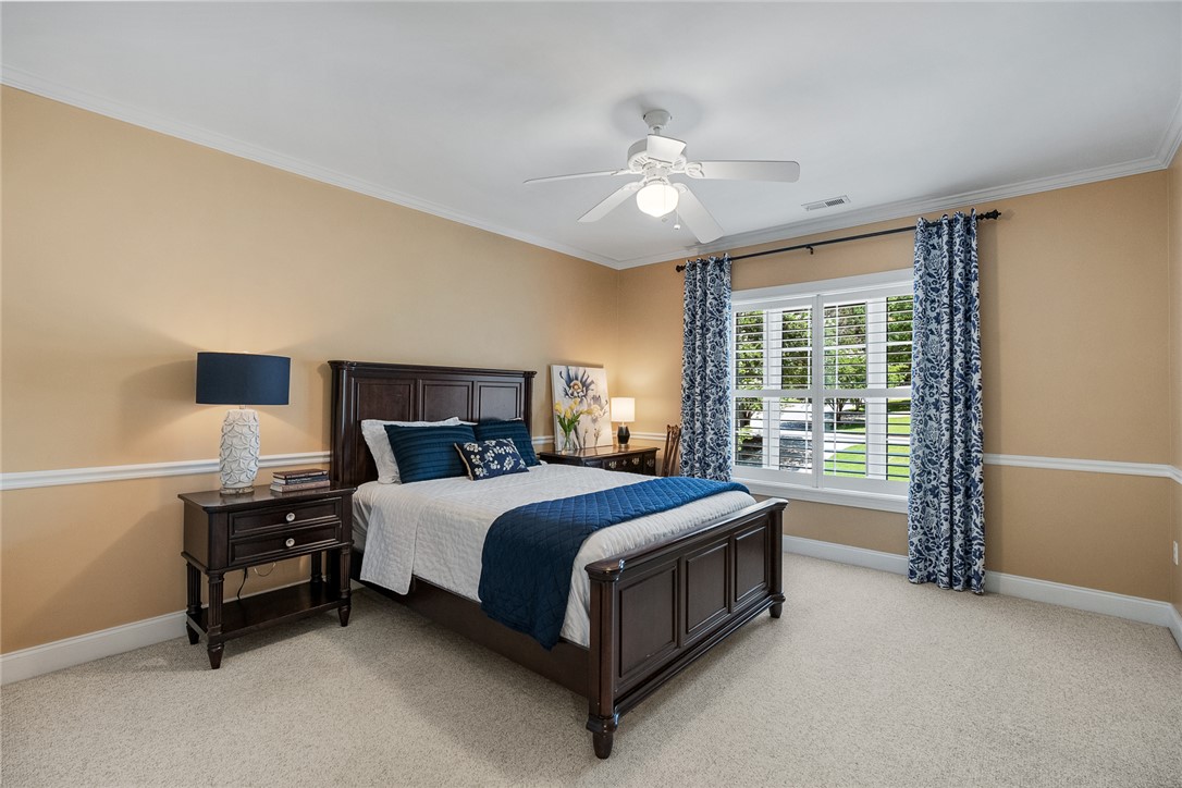 200 Graylyn Drive Anderson, SC 29621 - Photo 26 of 48 A comforting bedroom features a ceiling fan, crown molding, and plantation shutters for serene repose.