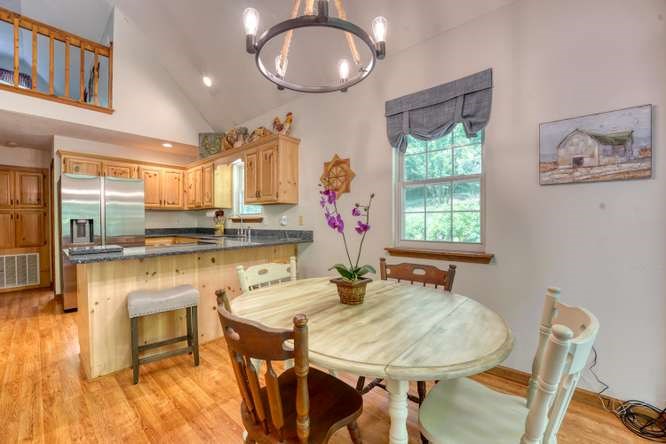 3333 Ellington Road Hayesville, NC 28904 - Photo 32 of 56 a kitchen with a table chairs a stove a dining table and chairs