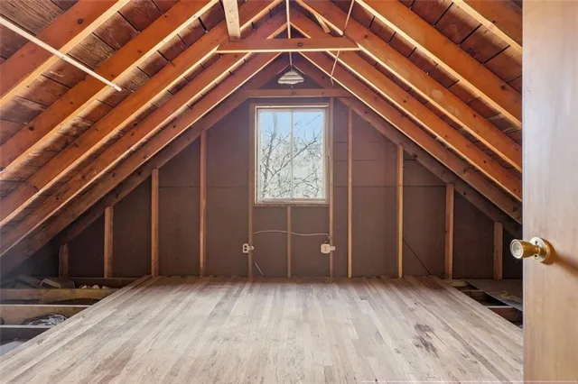 a view of a room with wooden floor and windows