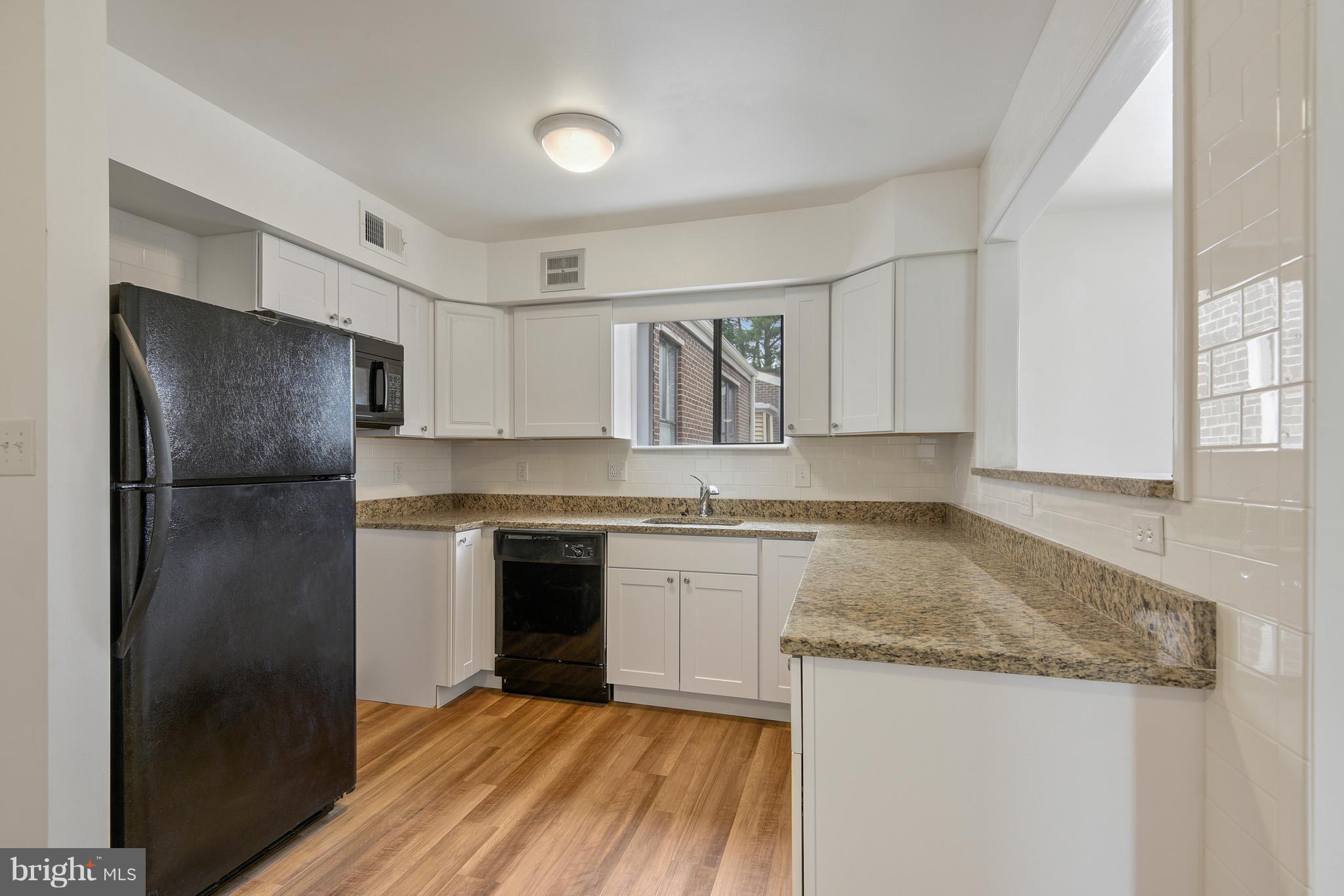3224 Spartan Road, Unit 3E6 Olney, MD 20832 - Photo 4 of 27 a kitchen with a refrigerator and a sink