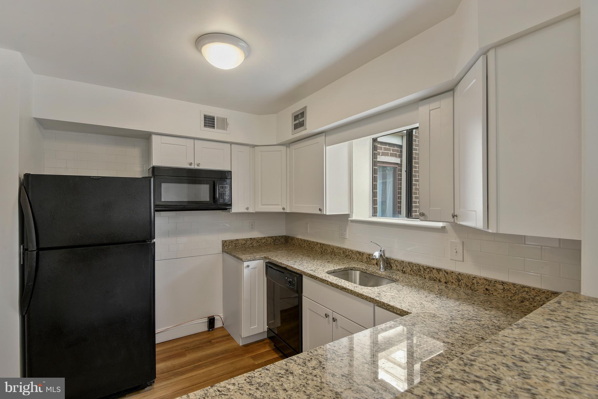 3224 Spartan Road, Unit 3E6 Olney, MD 20832 - Photo 5 of 27 a kitchen with a refrigerator and a sink