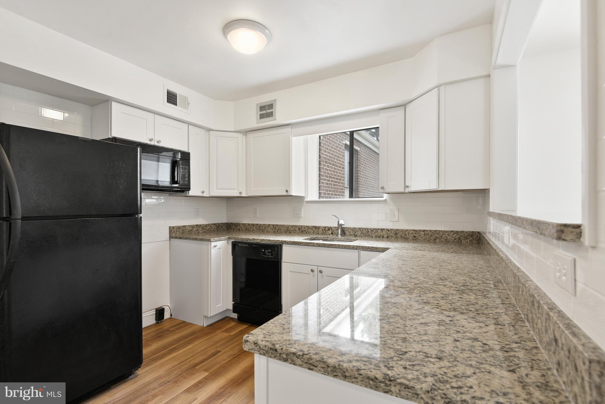 3224 Spartan Road, Unit 3E6 Olney, MD 20832 - Photo 6 of 27 a kitchen with stainless steel appliances granite countertop a refrigerator a stove a sink and a microwave