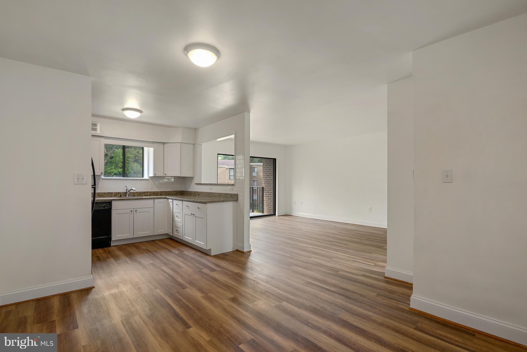 3224 Spartan Road, Unit 3E6 Olney, MD 20832 - Photo 7 of 27 a large kitchen with a wooden floor and stainless steel appliances