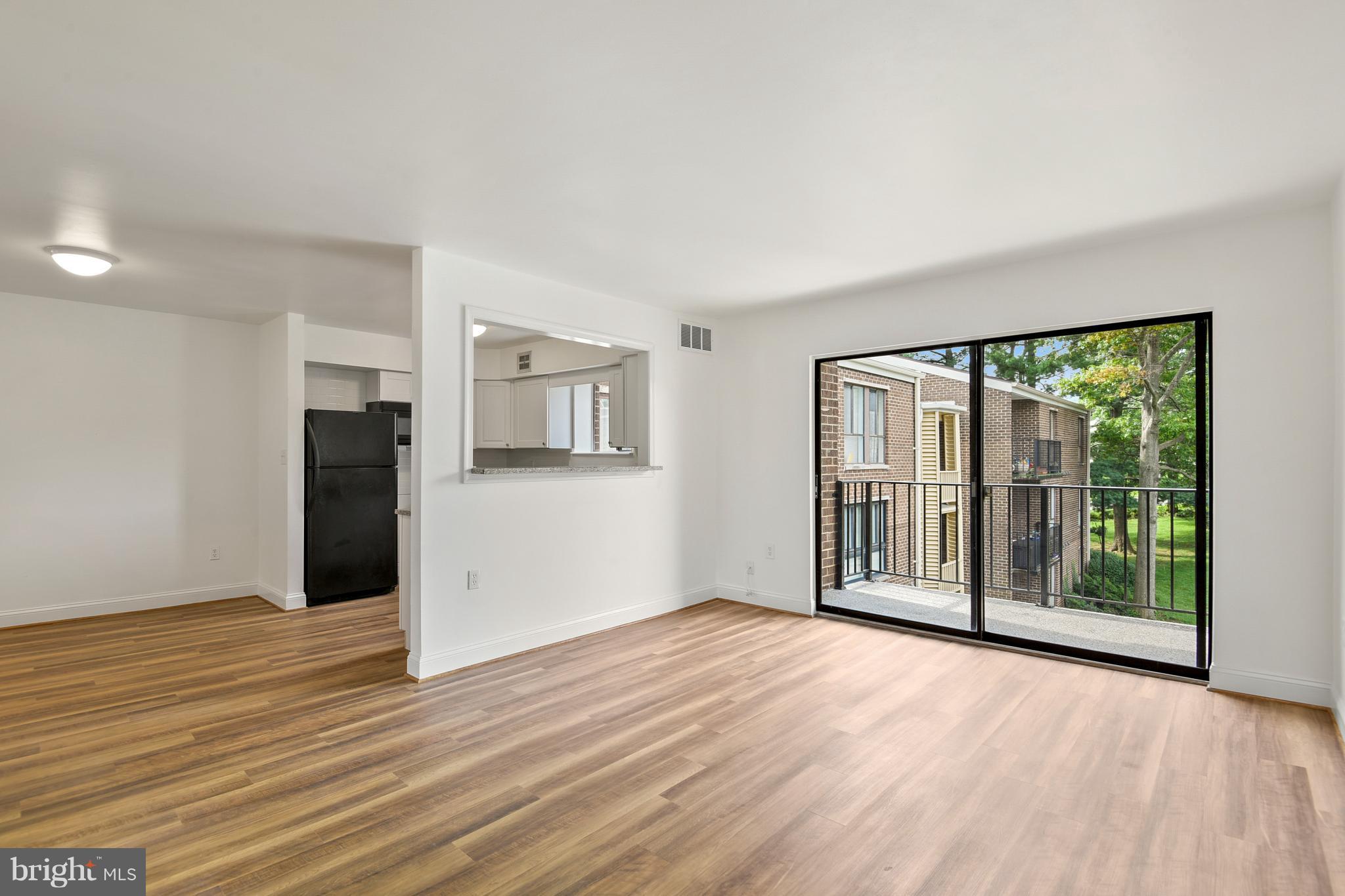 3224 Spartan Road, Unit 3E6 Olney, MD 20832 - Photo 8 of 27 an empty room with wooden floor and windows