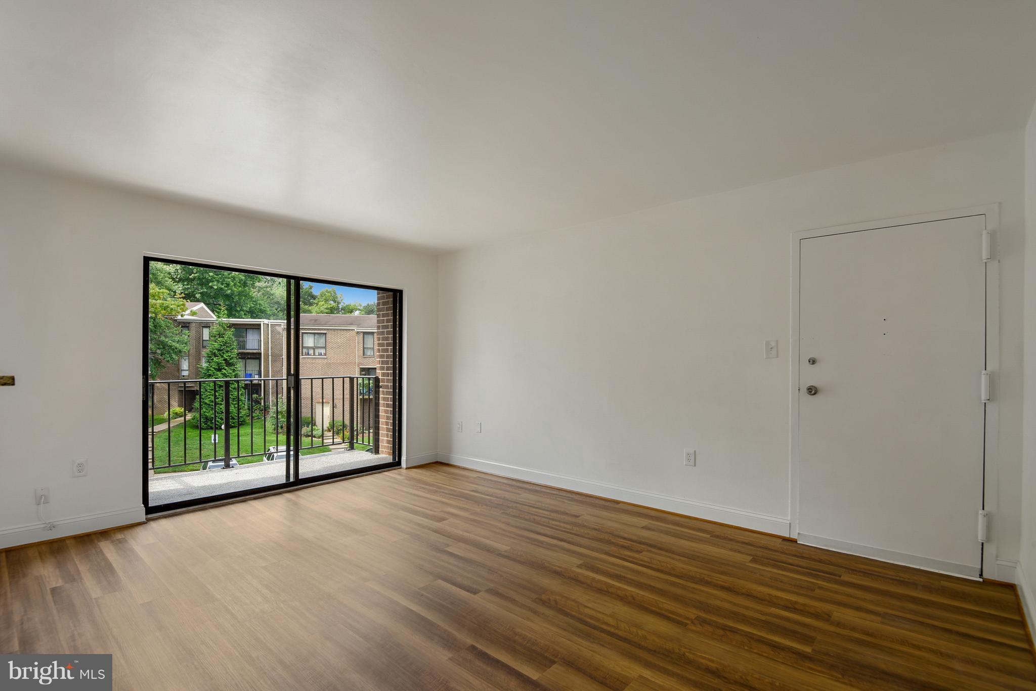 3224 Spartan Road, Unit 3E6 Olney, MD 20832 - Photo 10 of 27 a view of an empty room with wooden floor and a window