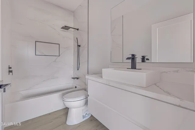 a bathroom with a toilet sink and bathtub