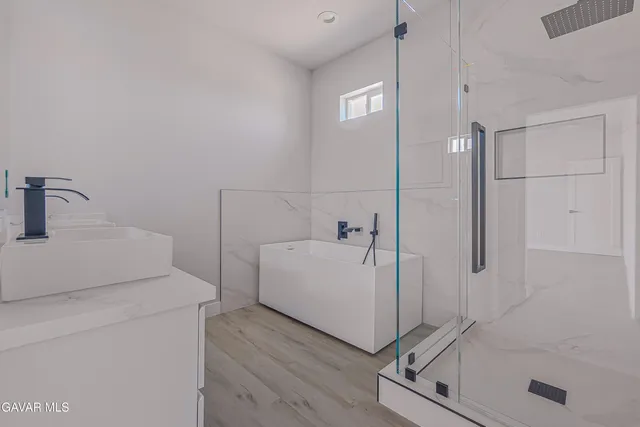 a bathroom with a sink and shower