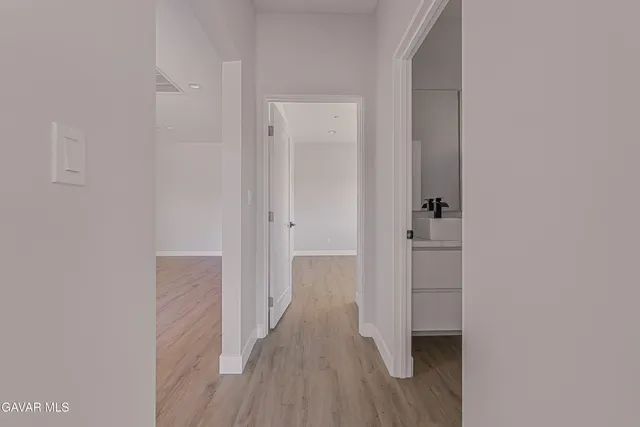 a view of a room with wooden floor