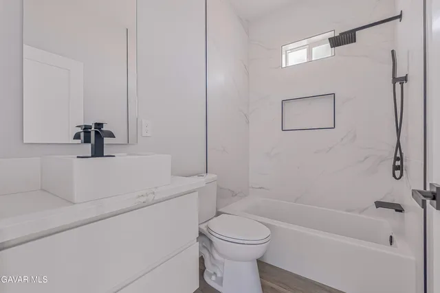 a bathroom with a sink a toilet and a bathtub