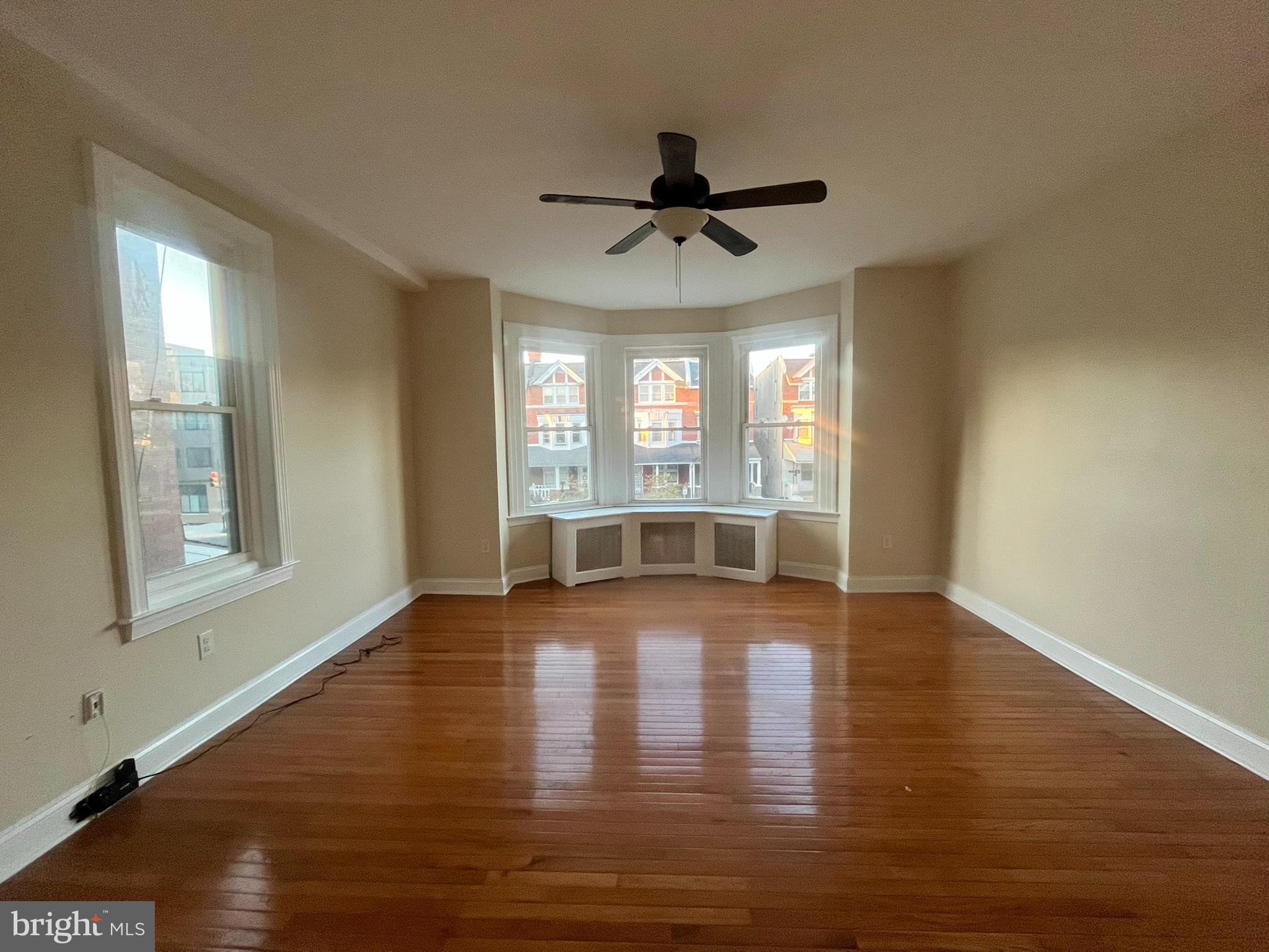 4946 Walnut Street, Unit 2F Philadelphia, PA 19139 - Photo 1 of 20 a view of empty room with wooden floor and fan