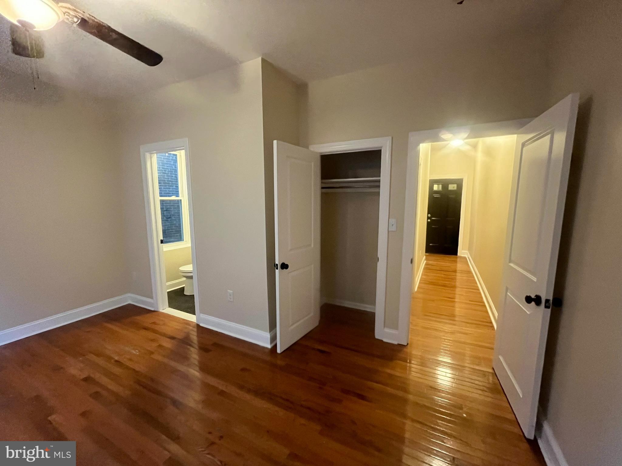 4946 Walnut Street, Unit 2F Philadelphia, PA 19139 - Photo 11 of 20 an empty room with wooden floor and windows
