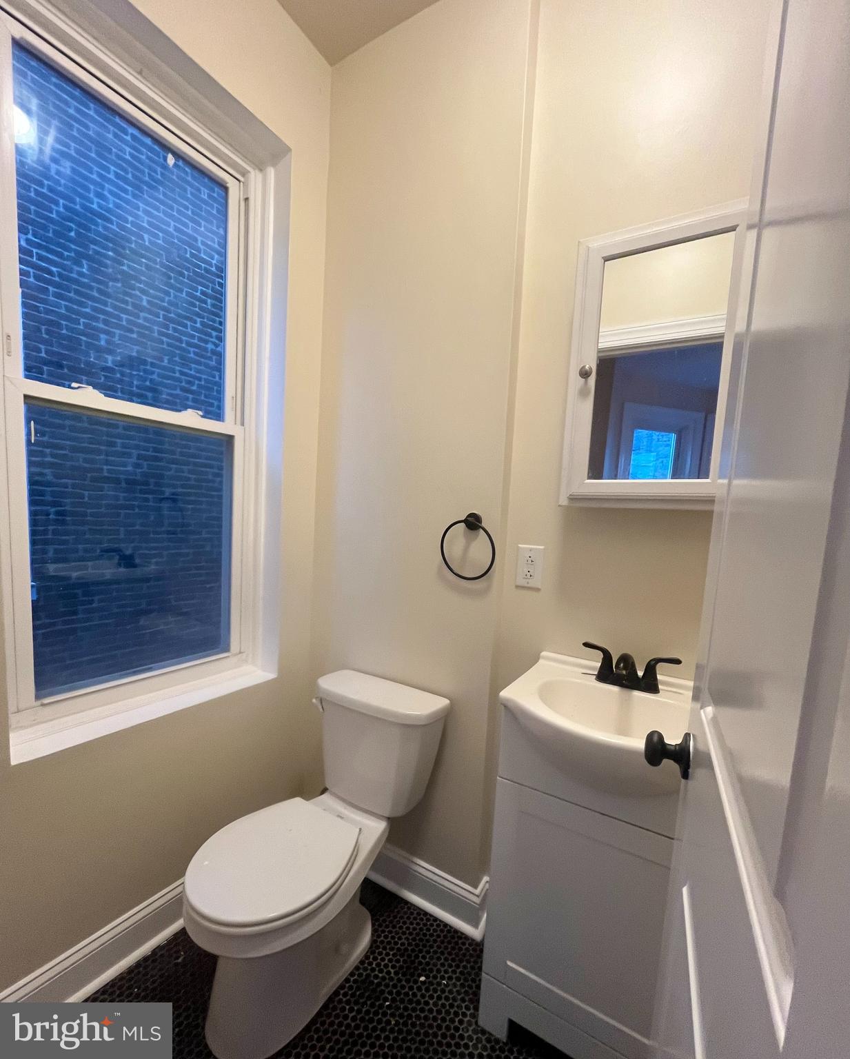 4946 Walnut Street, Unit 2F Philadelphia, PA 19139 - Photo 12 of 20 a white toilet sitting next to a bathroom sink and vanity