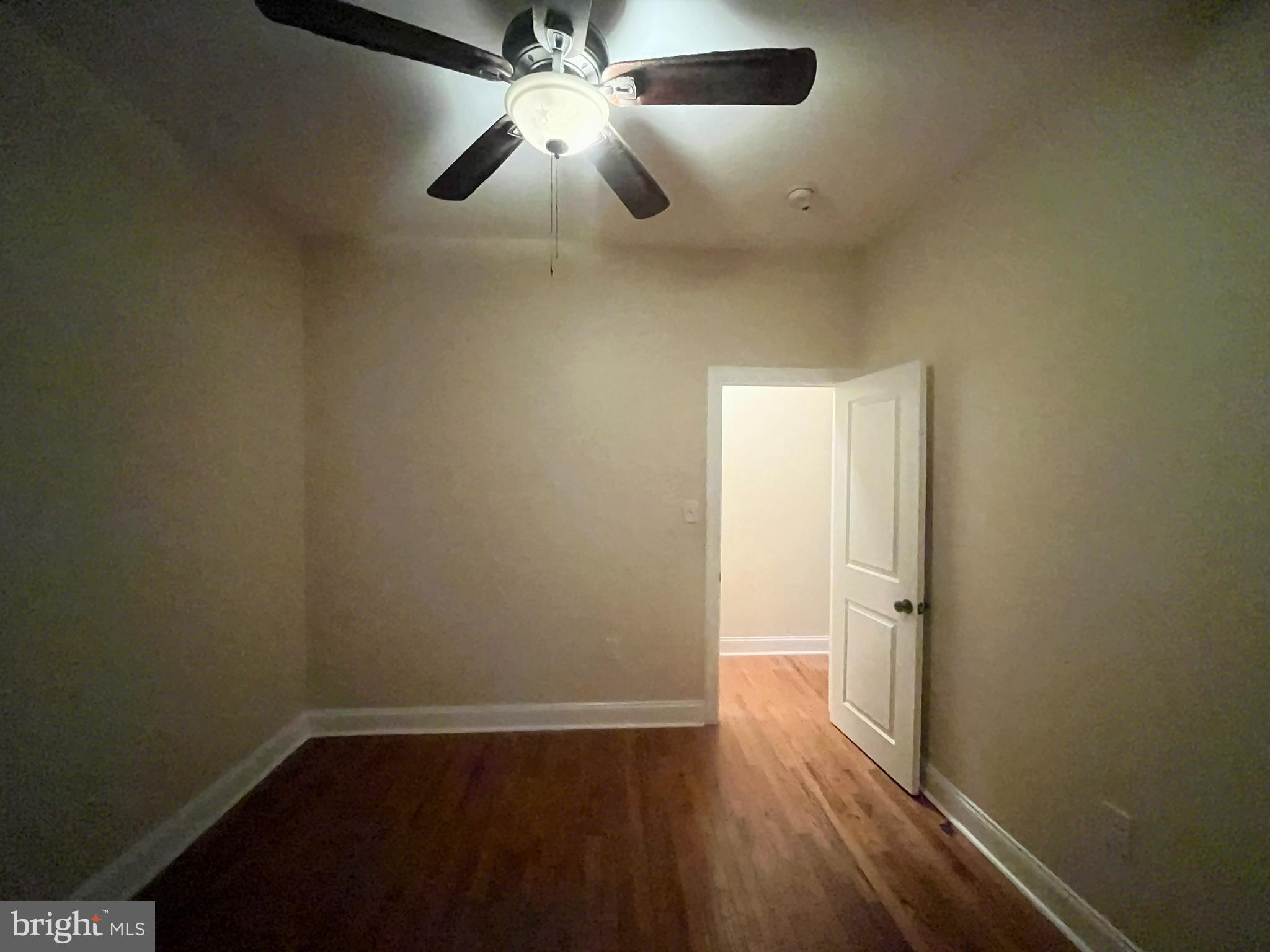 4946 Walnut Street, Unit 2F Philadelphia, PA 19139 - Photo 14 of 20 an empty room with wooden floor closet and windows