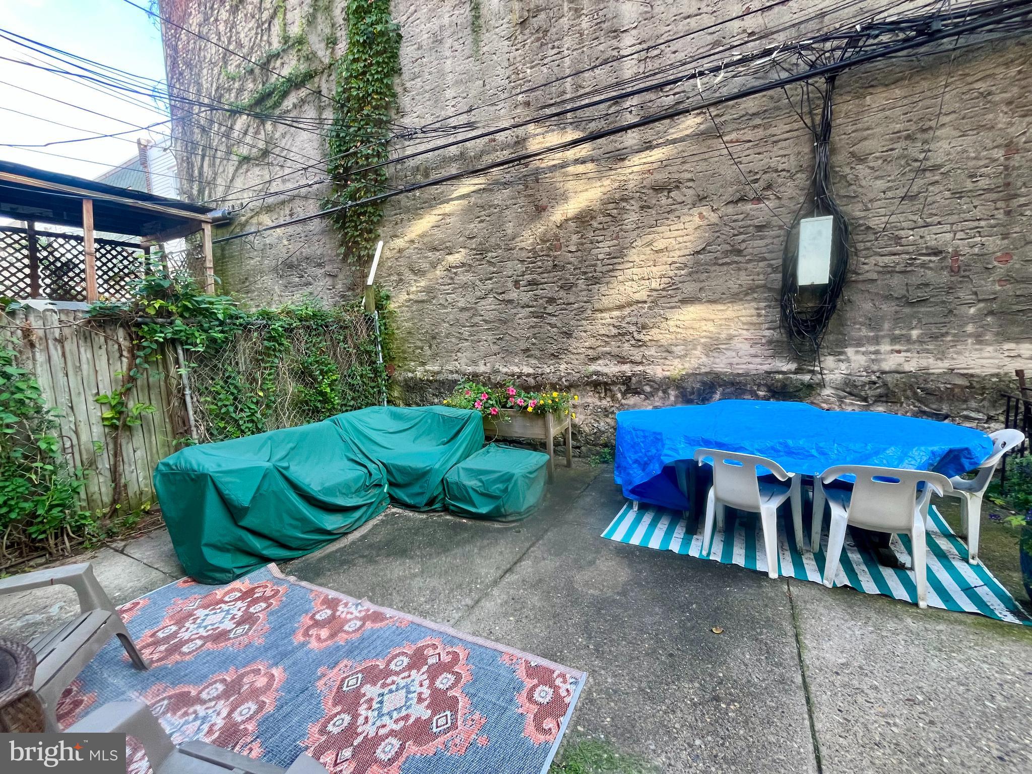 4946 Walnut Street, Unit 2F Philadelphia, PA 19139 - Photo 17 of 20 a view of an outdoor sitting area with brick walls