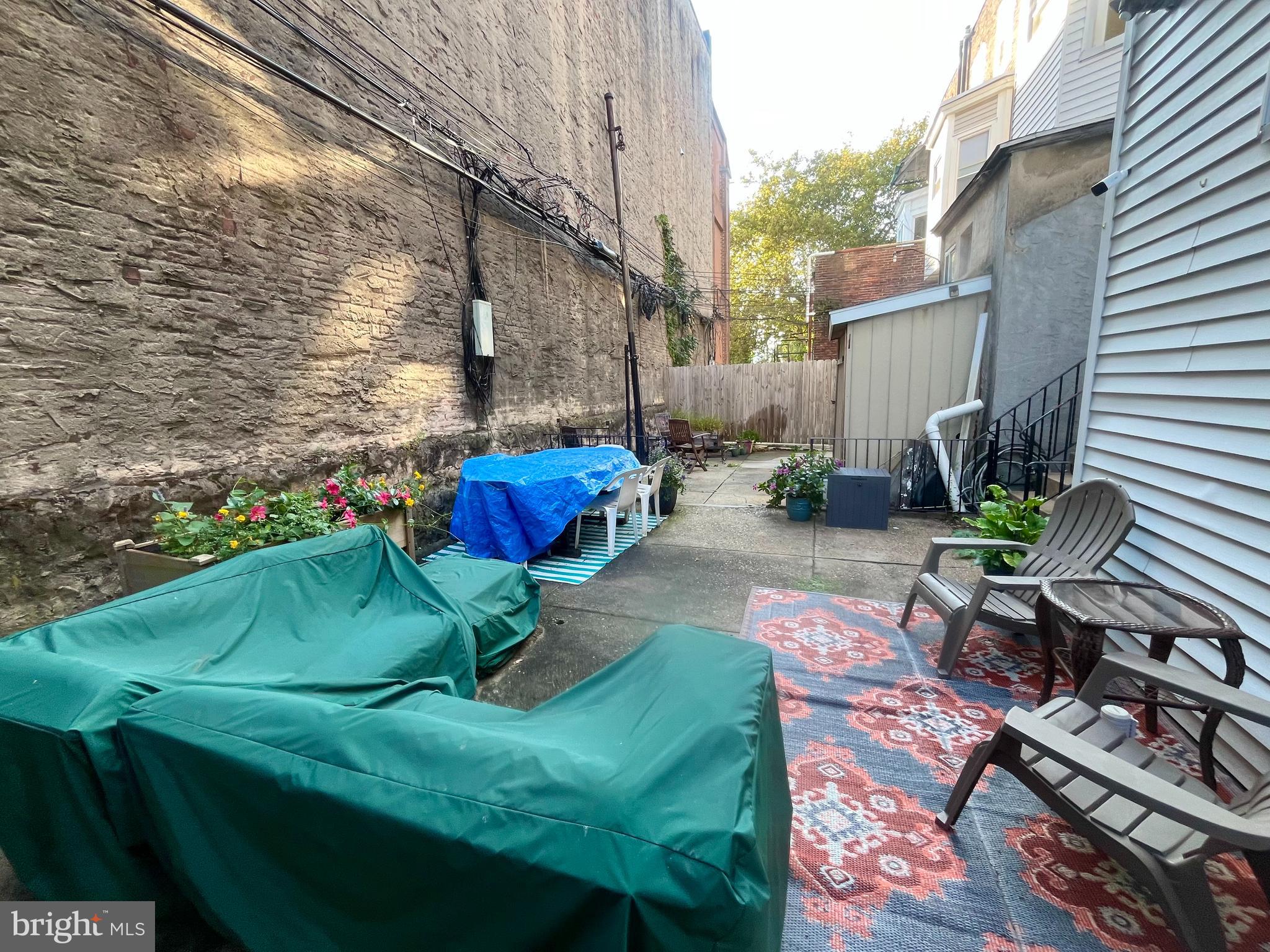 4946 Walnut Street, Unit 2F Philadelphia, PA 19139 - Photo 18 of 20 a backyard of a house with outdoor seating