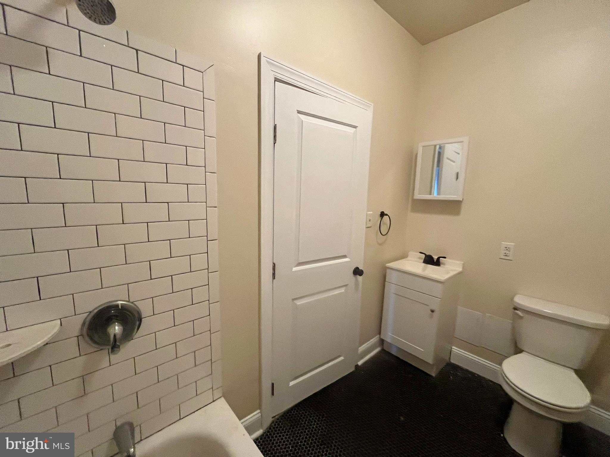 4946 Walnut Street, Unit 2F Philadelphia, PA 19139 - Photo 8 of 20 a bathroom with a toilet and a shower